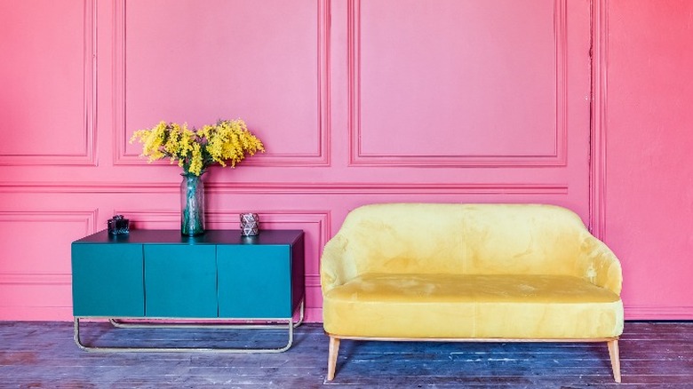 Yellow sofa on pink wall