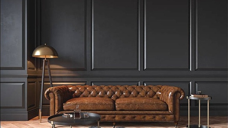 Black walls with brown couch