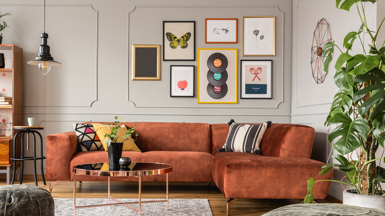 Eclectic room with brown couch