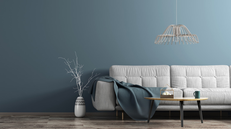 Blue wall with gray couch