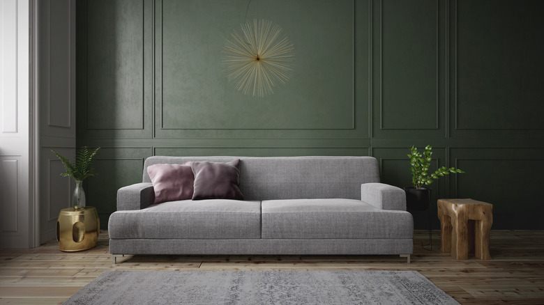 Gray couch, green accent wall