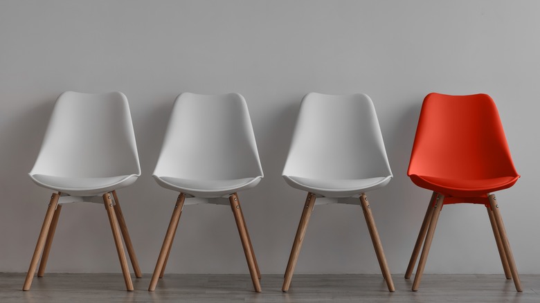 white chairs with one red chair