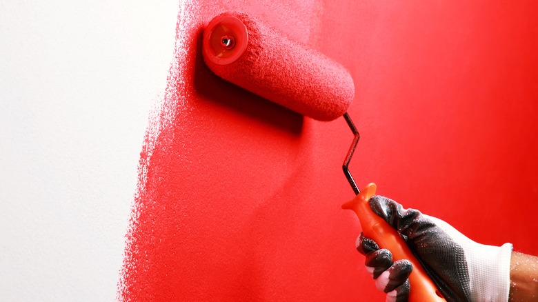 Red paint rolled onto wall