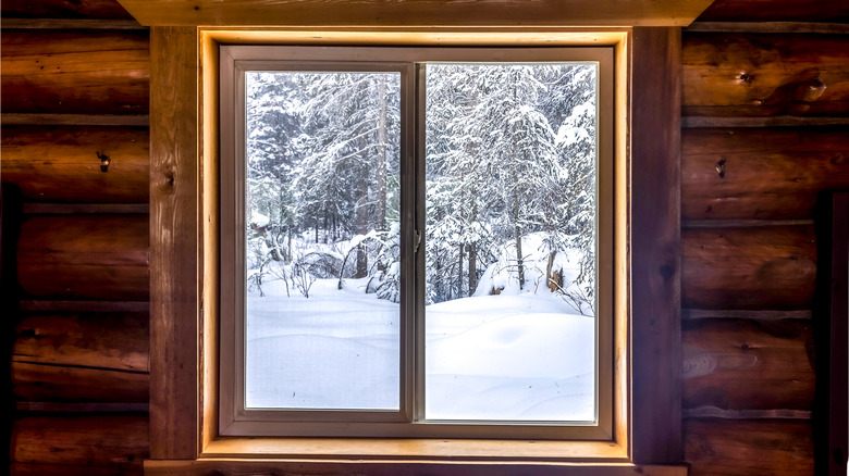 snow outside cabin window