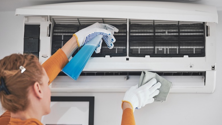 Woman cleaning AC