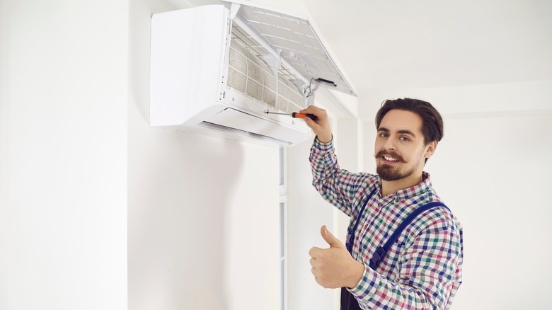 Technician inspecting AC