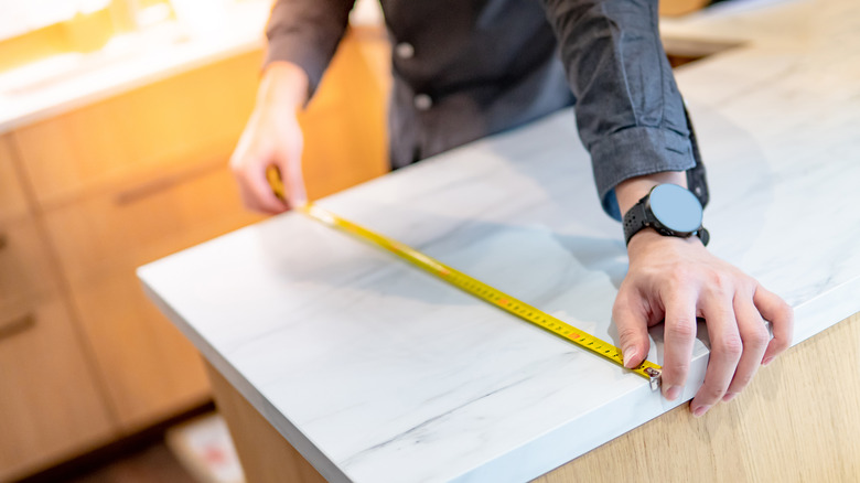 contractor measuring countertop