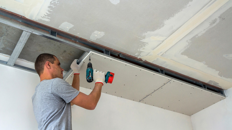 homeowner installing drywall