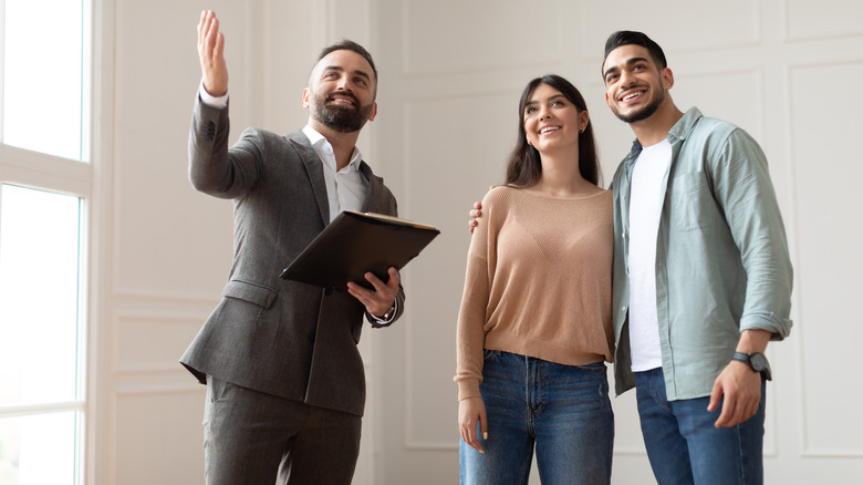 realtor showing home to couple