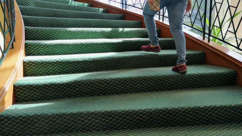 person climbing green stairs