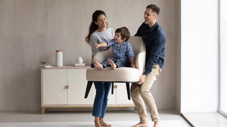 family arranging furniture