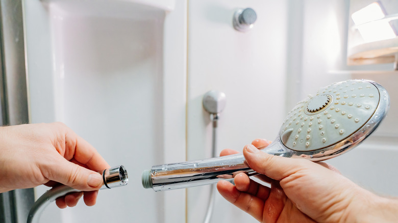 Person fixing shower head