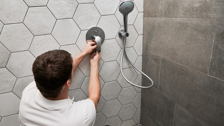 Man working on a shower faucet handle