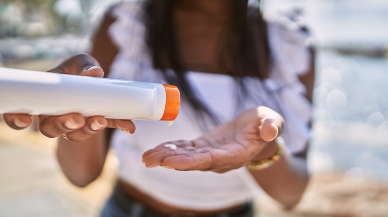 Woman applying sunscreen