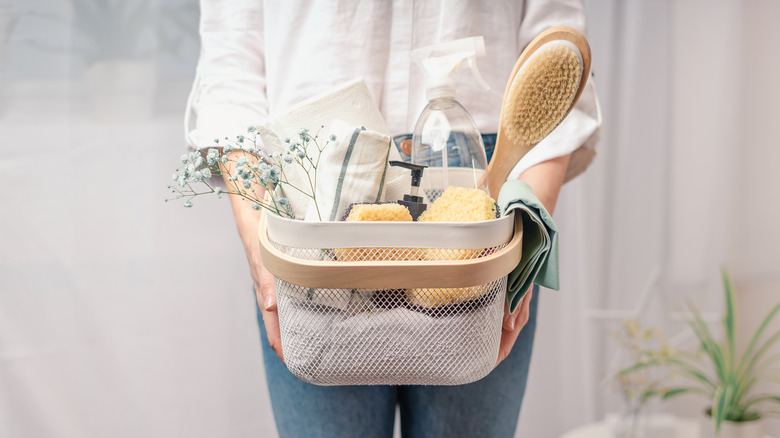 Person holding laundry supplies