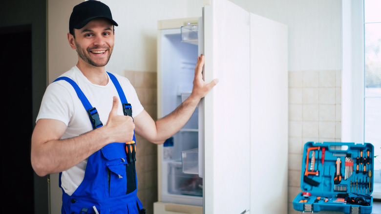 refrigerator technician with tools
