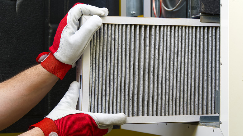 hands fitting air filter