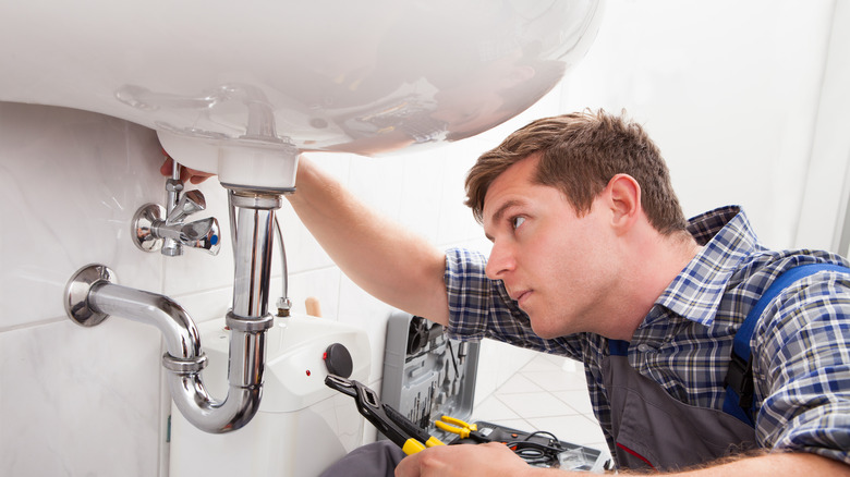 plumber repairing sink