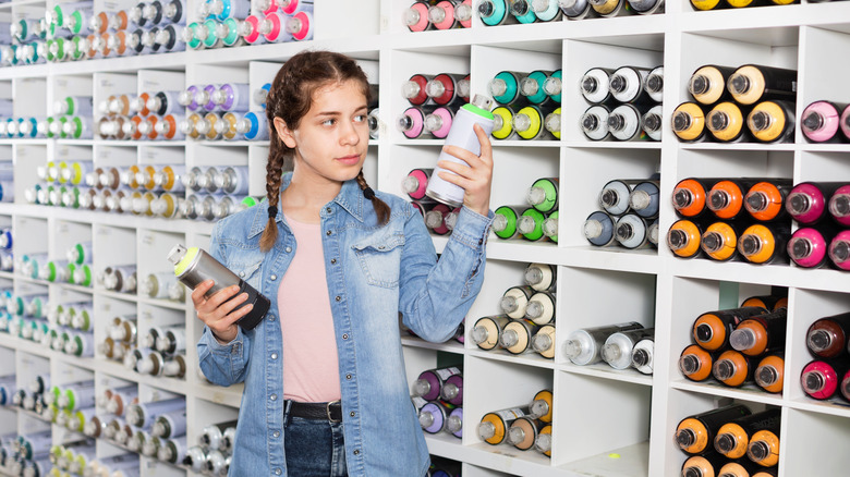 Girl in spraay paint aisle