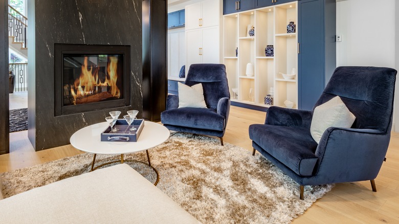 Fireplace and blue velvet chairs 