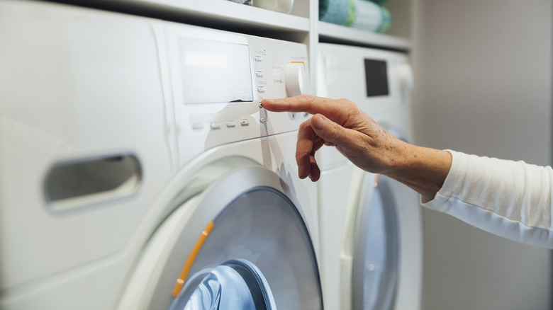 Person setting dryer cycle