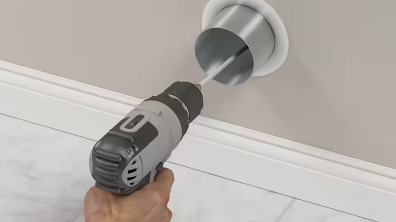 Power drill with vent cleaner attachment