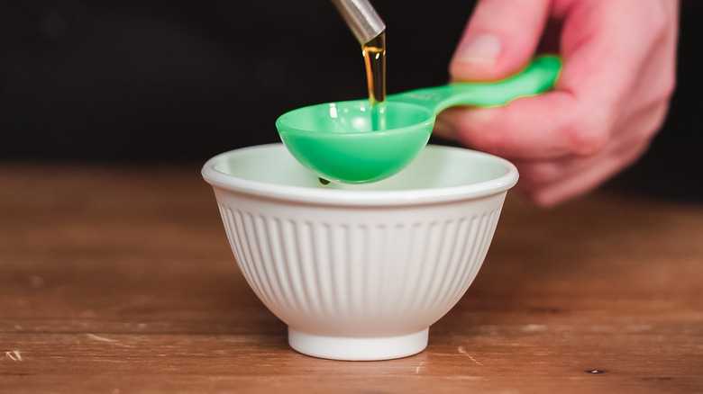 olive oil in measuring spoon 