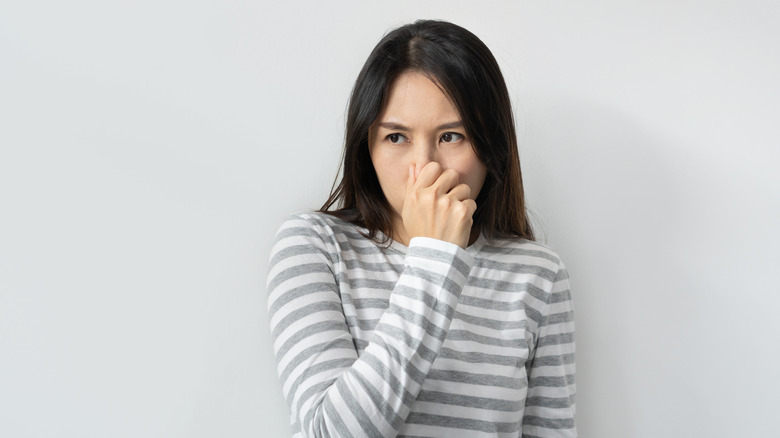 Woman covering nose