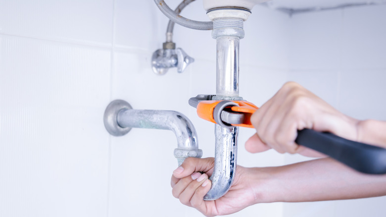 Plumber working on bathroom system