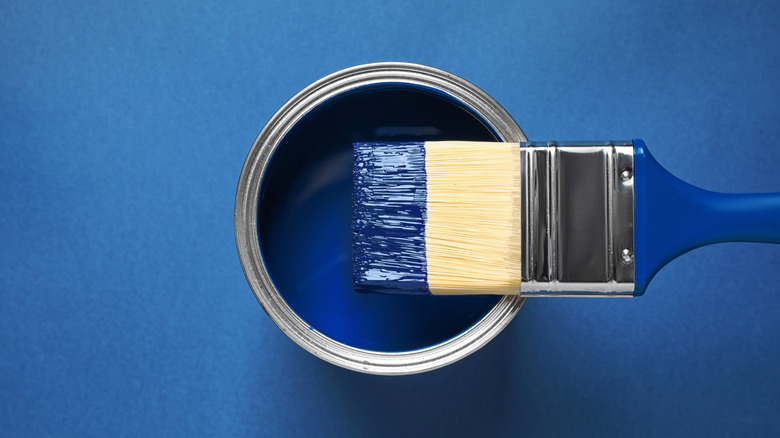 blue paint can and brush