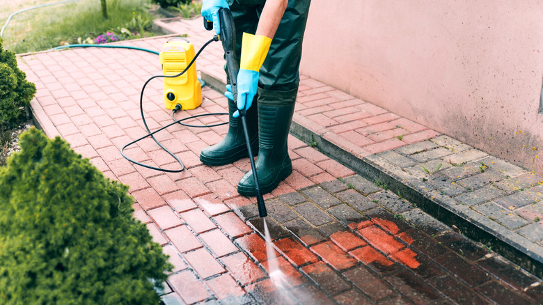 Man cleaning pavement