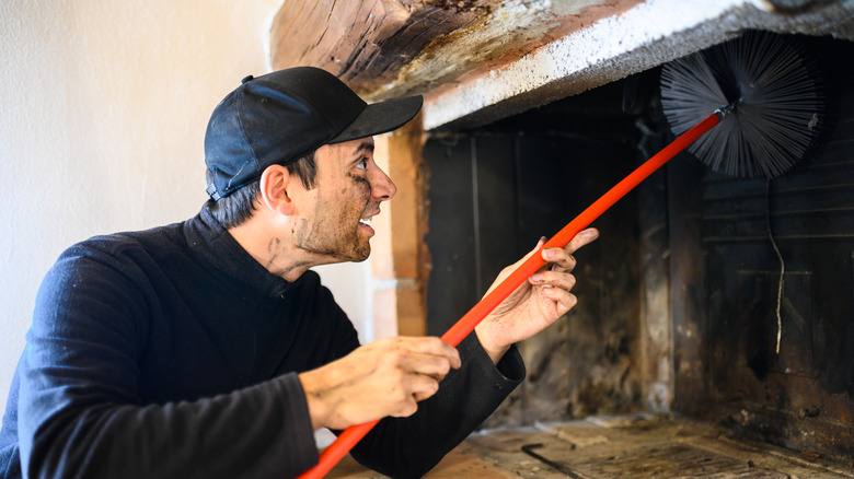 Chimney sweep cleaning fireplace