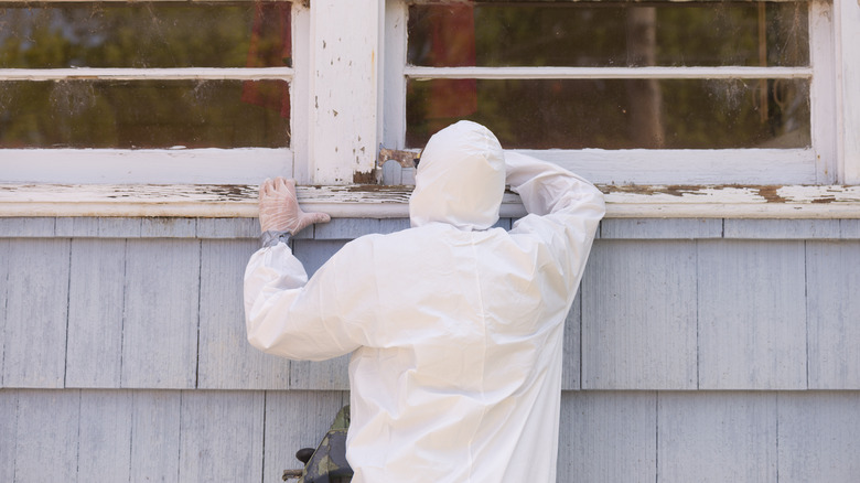 Person scraping old paint