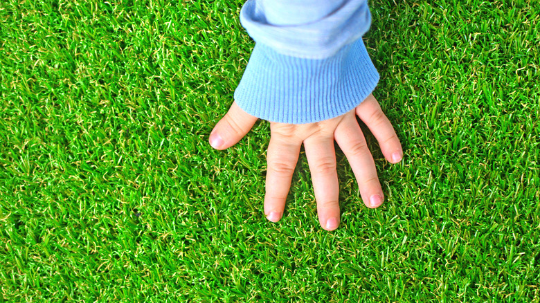 A hand on artificial grass 