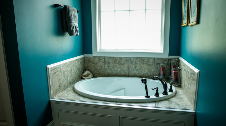 teal bathroom with round tub