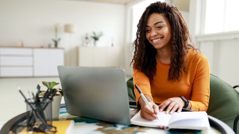 Woman writes in notebook