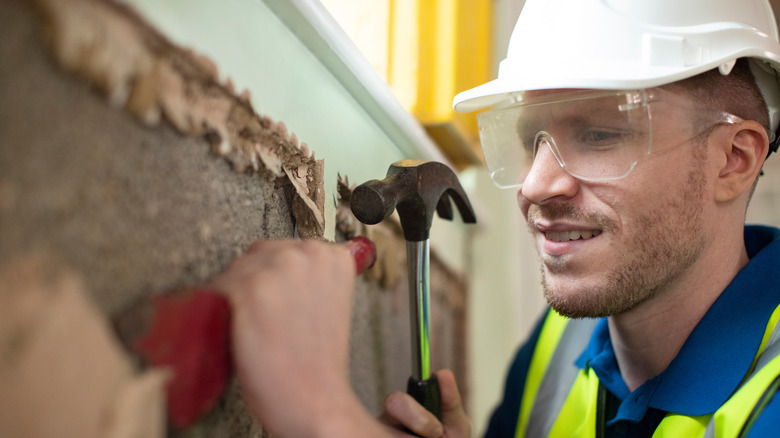 construction worker chipping cement