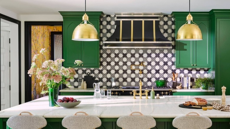 kitchen with green cabinets and patterned backsplash