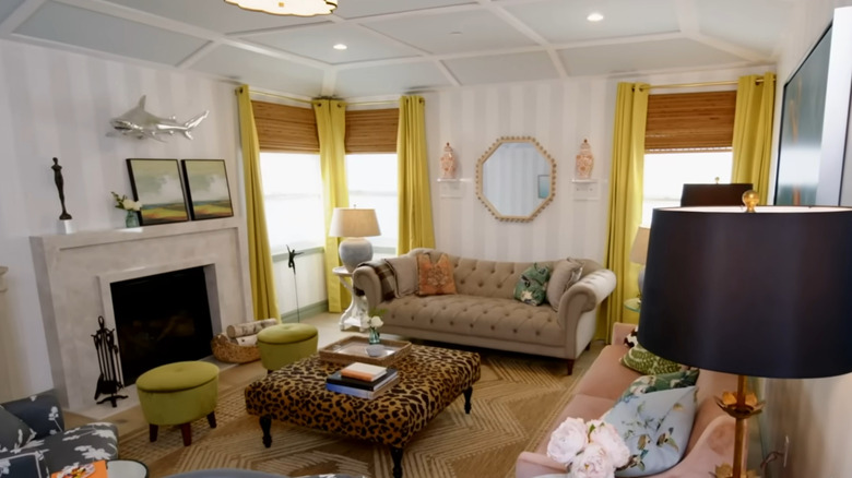 living room with leopard print ottoman and yellow curtains