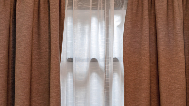 Layered curtains on window