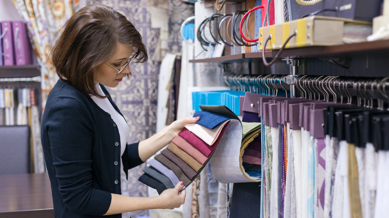 Woman looking at colored fabrics