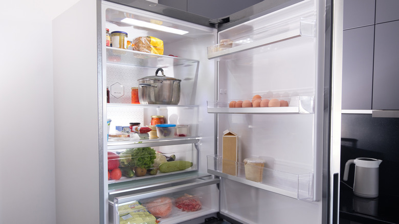 Open fridge with fruits
