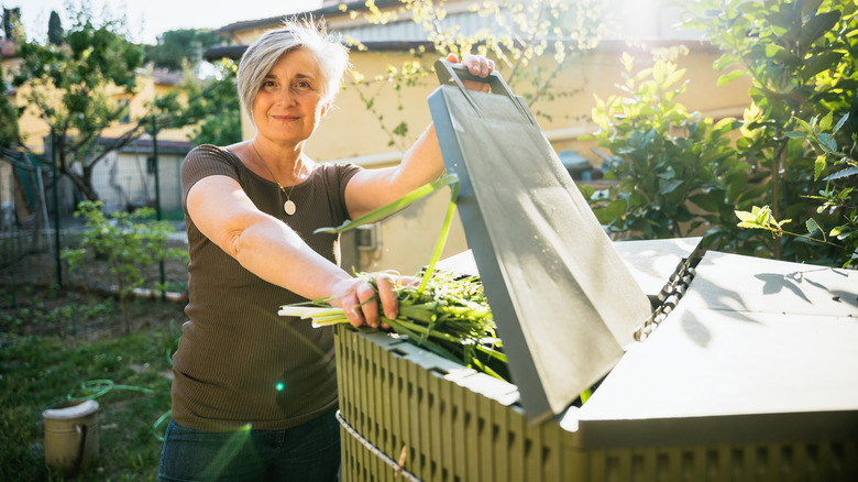 Person adding to compost bin