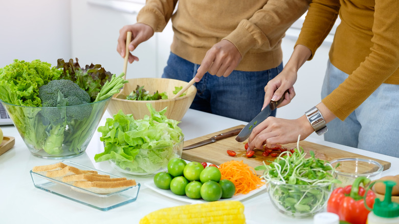 couple preparing food on counter