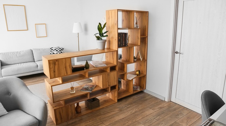 wooden bookcase dividing a space