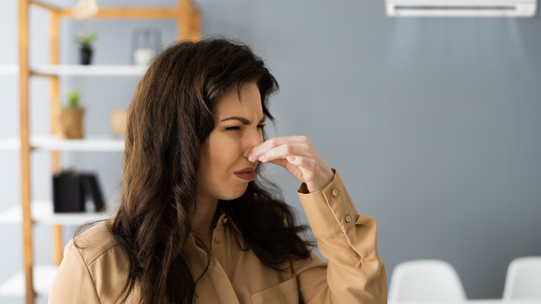 Person holding her nose