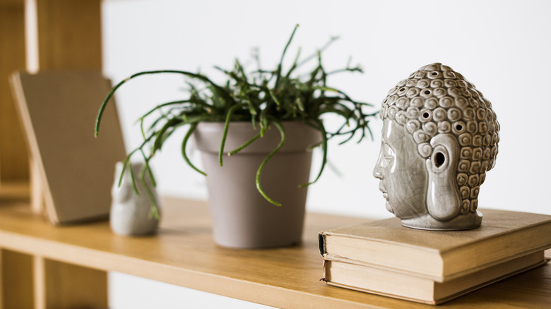 small bust on bookshelf 