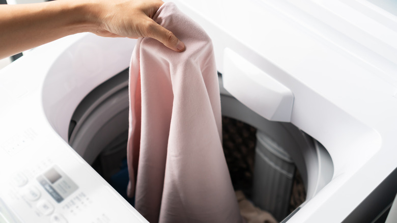 Putting clothe in washing machine