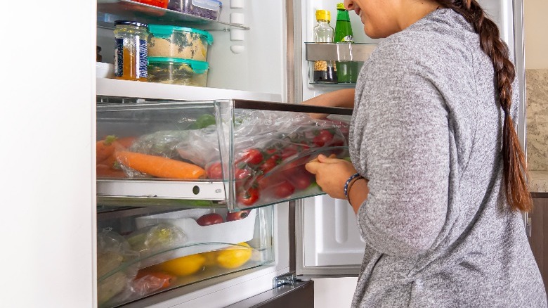 Woman opening refrigerator