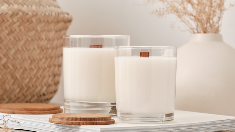 white candles in glass jar